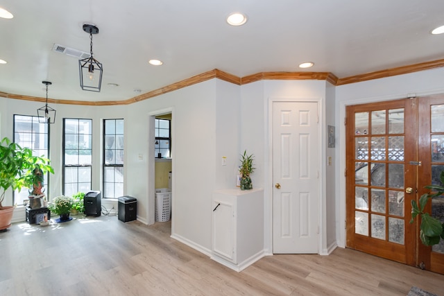 entrance foyer featuring french doors, light hardwood / wood-style floors, and ornamental molding