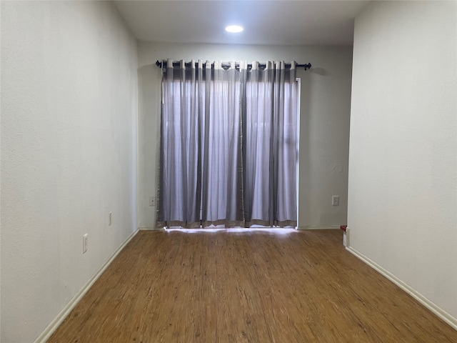 empty room featuring dark wood-type flooring