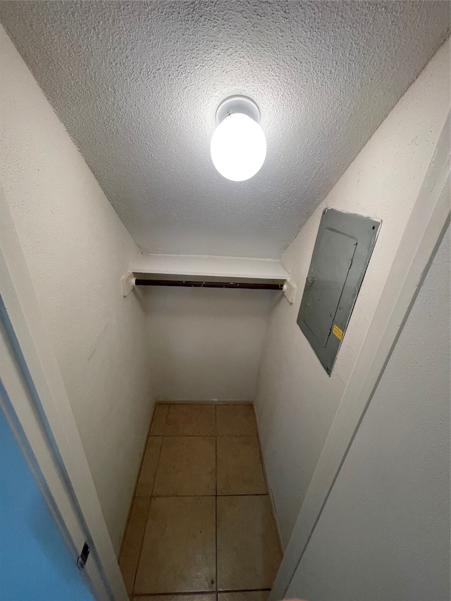 spacious closet featuring electric panel and tile patterned flooring