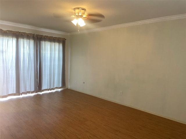 empty room with crown molding, dark hardwood / wood-style floors, and ceiling fan