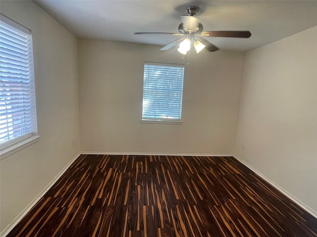 unfurnished room with dark wood-type flooring and ceiling fan