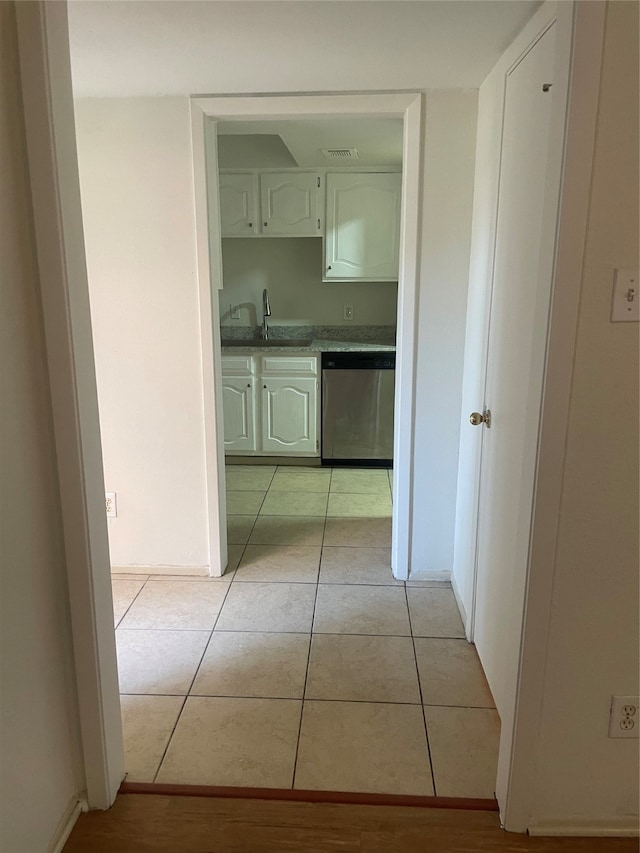 hallway featuring light tile patterned floors