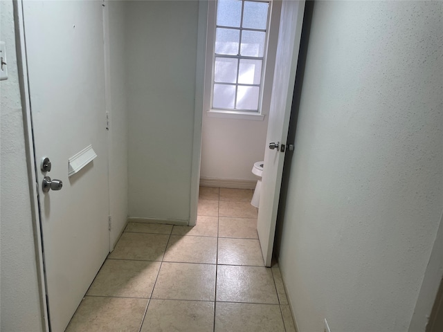 bathroom with toilet and tile patterned flooring