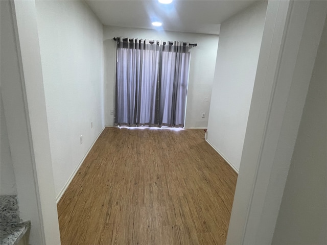 unfurnished room with hardwood / wood-style floors