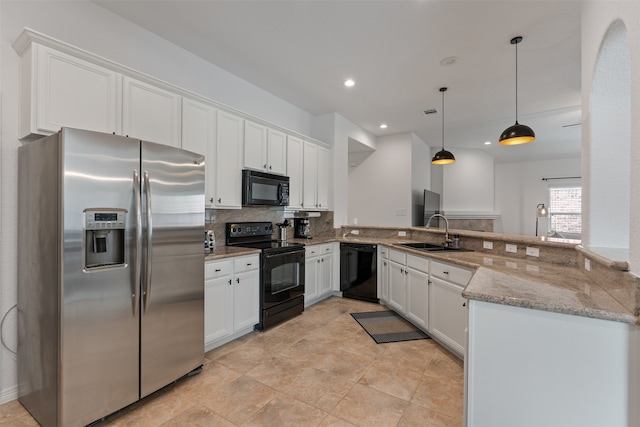 kitchen with white cabinetry, black appliances, and kitchen peninsula