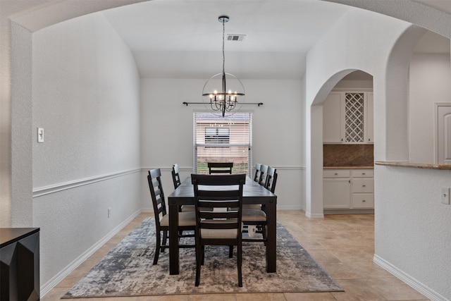 dining area featuring an inviting chandelier