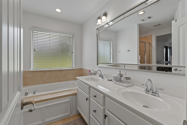 bathroom featuring vanity, shower with separate bathtub, and tile patterned flooring