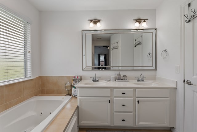 bathroom featuring vanity and a relaxing tiled tub