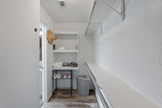 spacious closet featuring hardwood / wood-style flooring