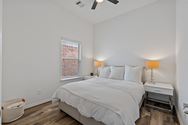 bedroom featuring dark hardwood / wood-style floors, vaulted ceiling, and ceiling fan