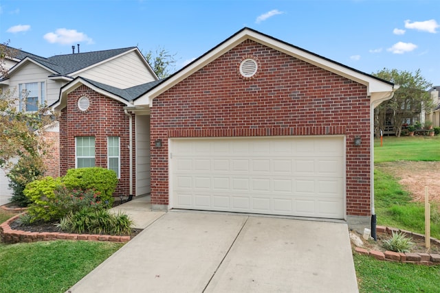 view of property with a front yard and a garage