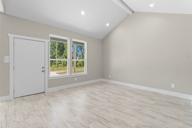 spare room with lofted ceiling with beams