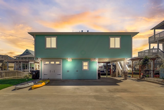 22819 Vida St, Galveston, TX 77554 - view of front of house featuring stairs, an attached garage, driveway, and a carport