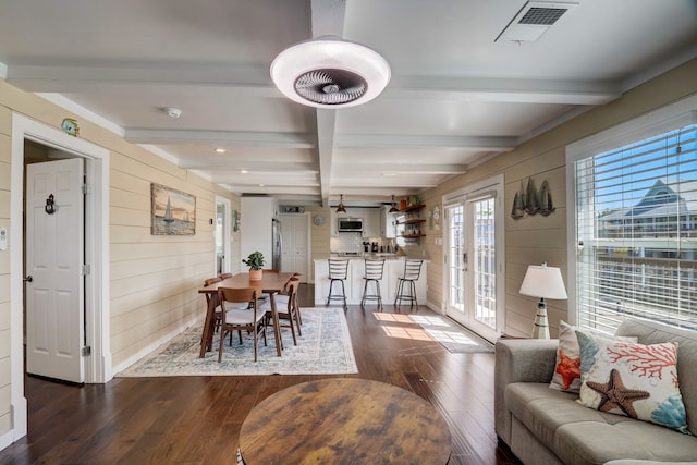 22819 Vida St, Galveston, TX 77554 - dining space with beam ceiling, wood walls, dark wood-type flooring, and recessed lighting