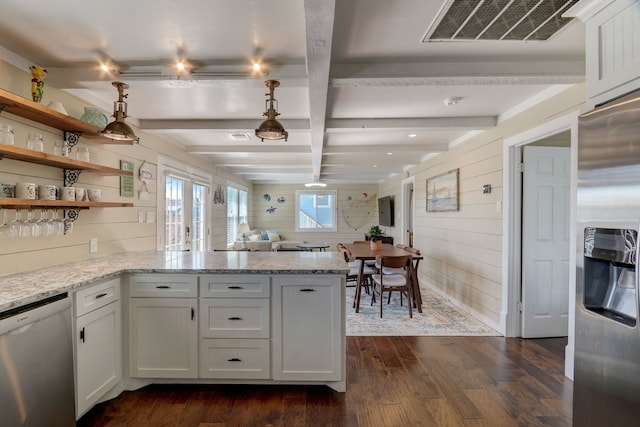22819 Vida St, Galveston, TX 77554 - kitchen with appliances with stainless steel finishes, wood walls, dark wood-type flooring, a peninsula, and white cabinets