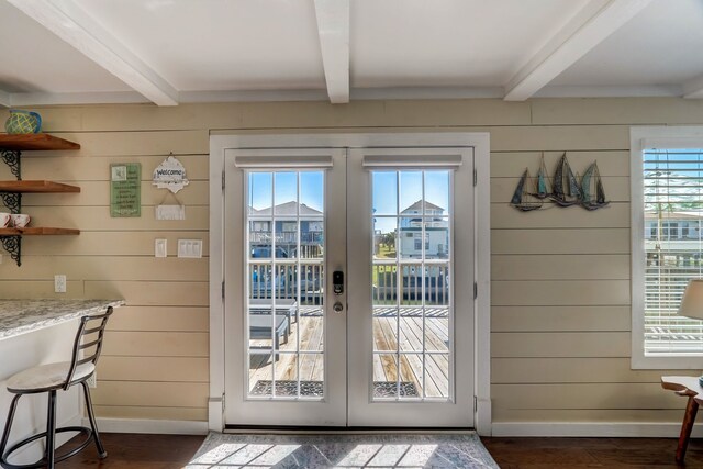 22819 Vida St, Galveston, TX 77554 - entryway with french doors, beam ceiling, plenty of natural light, wood walls, and dark wood-style flooring