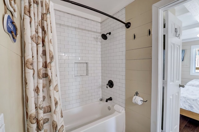 bathroom with wood-type flooring and shower / tub combo