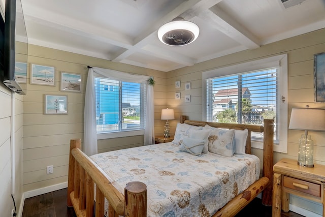 bedroom with coffered ceiling, wood walls, beamed ceiling, and dark hardwood / wood-style flooring