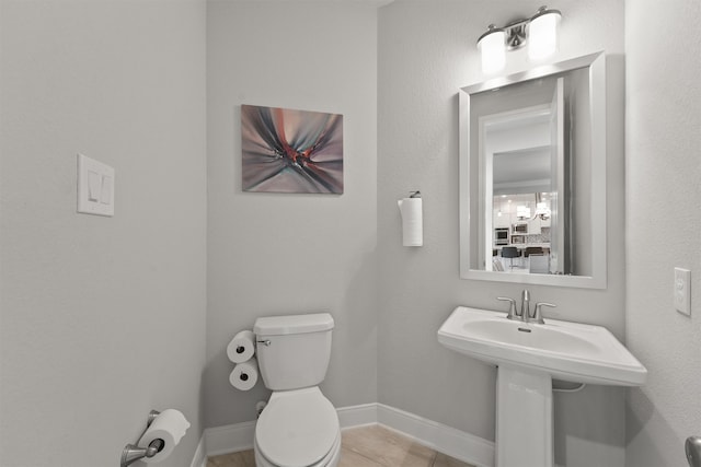 bathroom with toilet and tile patterned floors