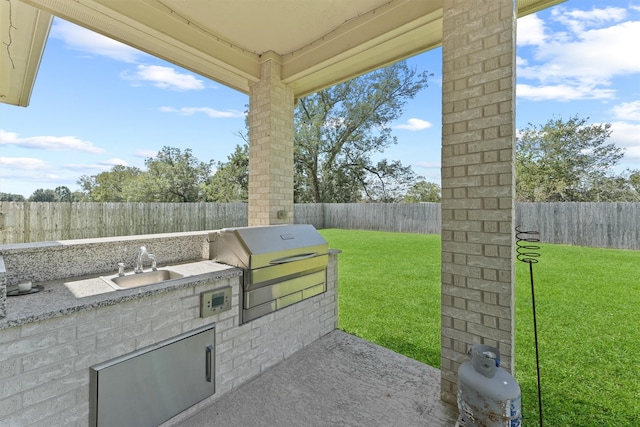 view of patio / terrace with an outdoor kitchen, sink, and a grill