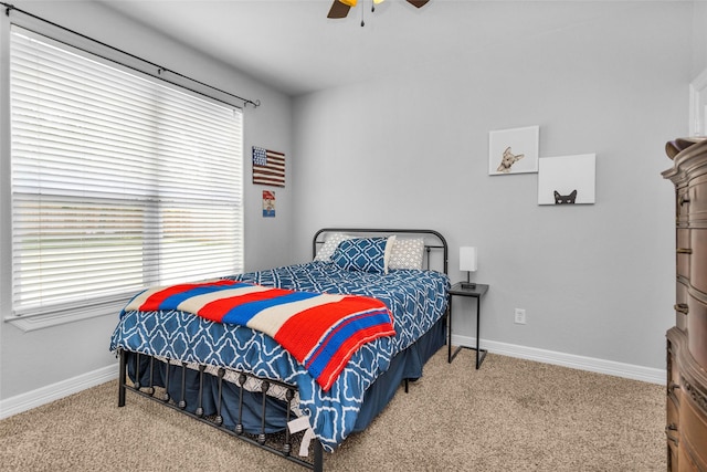 carpeted bedroom with multiple windows and ceiling fan