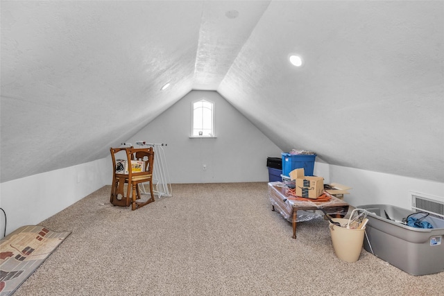 bonus room with carpet, a textured ceiling, and lofted ceiling