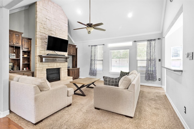 living room with crown molding, a fireplace, ceiling fan, and vaulted ceiling