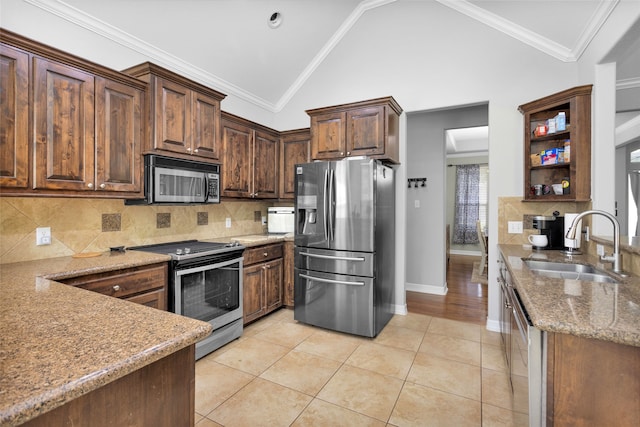 kitchen with high vaulted ceiling, sink, ornamental molding, light tile patterned flooring, and stainless steel appliances