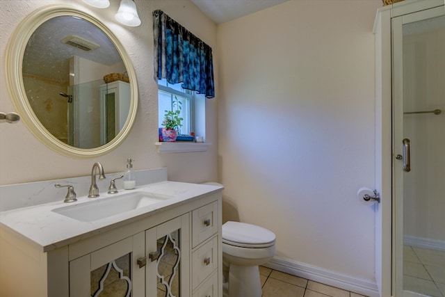 bathroom with toilet, an enclosed shower, vanity, and tile patterned flooring