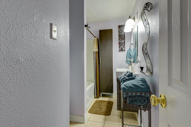 bathroom with tile patterned floors and shower / tub combo