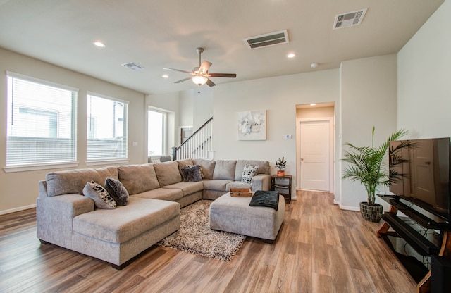 living room featuring ceiling fan and hardwood / wood-style flooring