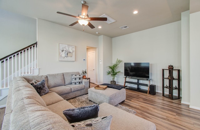 living room featuring light hardwood / wood-style flooring and ceiling fan