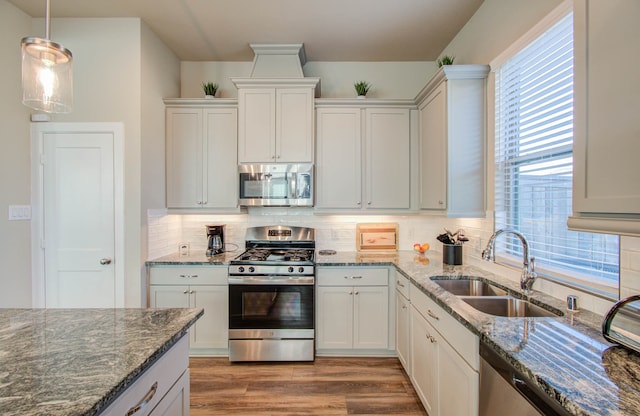 kitchen with white cabinetry, stainless steel appliances, and sink