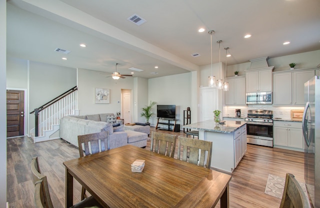 dining room featuring light hardwood / wood-style floors and ceiling fan