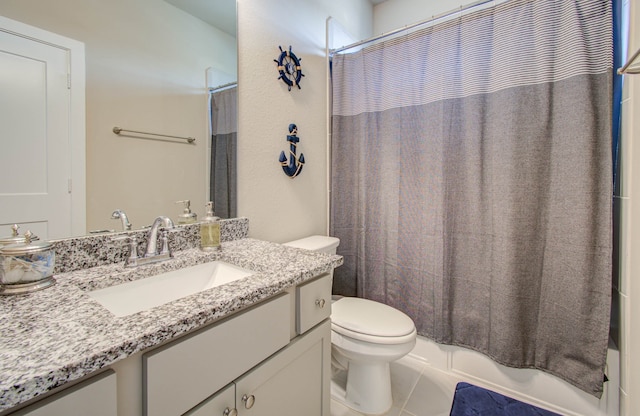 full bathroom featuring vanity, shower / tub combo, toilet, and tile patterned flooring