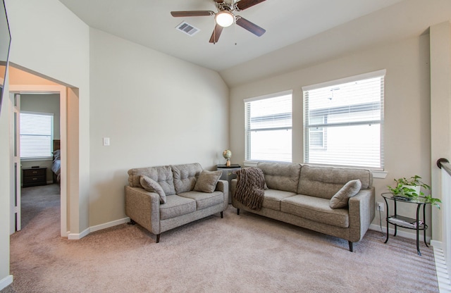 carpeted living room with ceiling fan and lofted ceiling