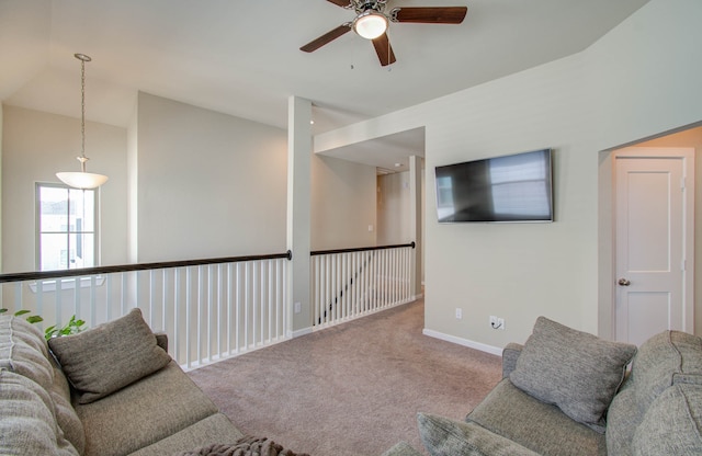 carpeted living room with ceiling fan