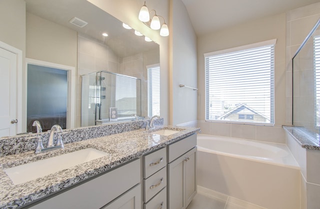 bathroom featuring vanity, separate shower and tub, lofted ceiling, and tile patterned flooring