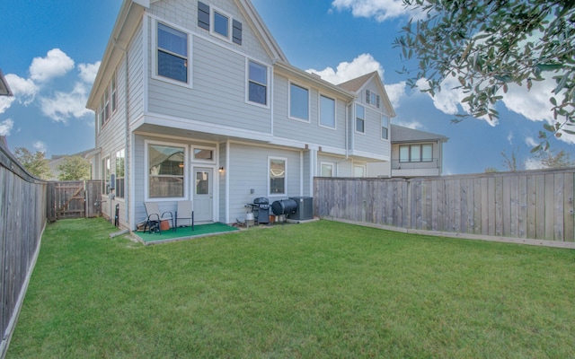 rear view of property with a patio and a lawn