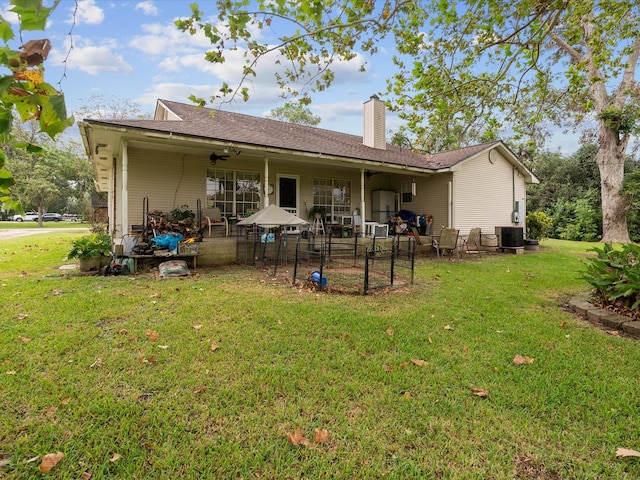 rear view of house featuring a yard, a patio area, and cooling unit