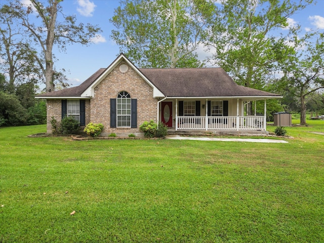 view of front of property with covered porch, a shed, and a front lawn