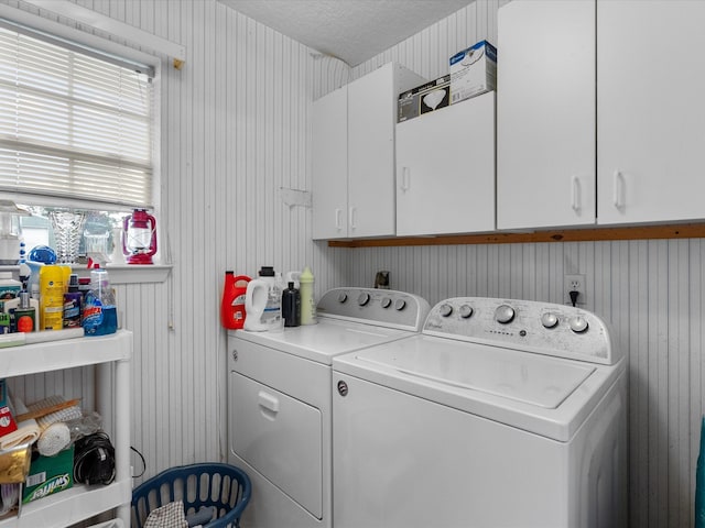 laundry room with independent washer and dryer, a textured ceiling, a healthy amount of sunlight, and cabinets