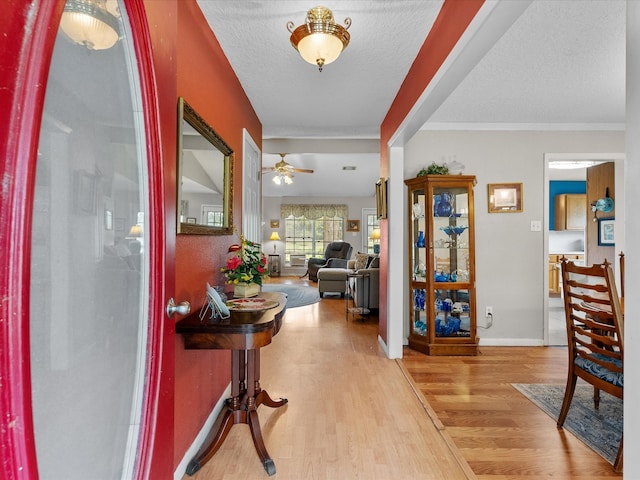 entrance foyer featuring ceiling fan, hardwood / wood-style flooring, and a textured ceiling