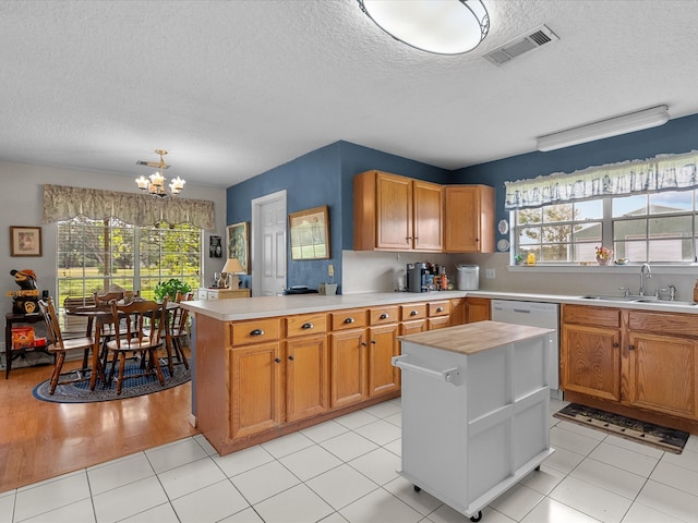 kitchen featuring a kitchen island, sink, and a healthy amount of sunlight