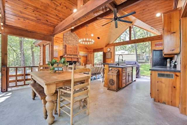 dining space with beamed ceiling, sink, wood ceiling, and a healthy amount of sunlight