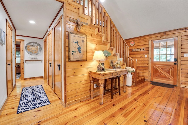 entryway with crown molding and light hardwood / wood-style flooring