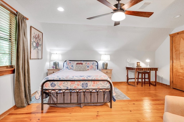 bedroom featuring light hardwood / wood-style flooring, ceiling fan, and vaulted ceiling