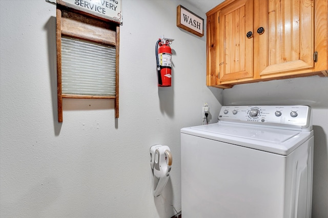 washroom with washer / dryer and cabinets