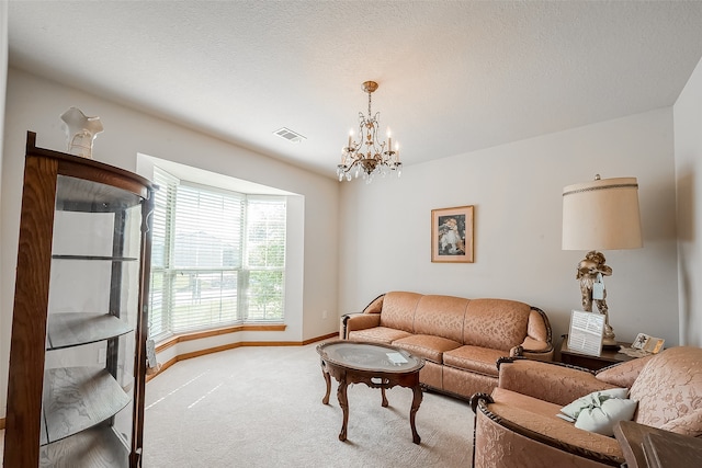 living room featuring a notable chandelier, a textured ceiling, and carpet flooring