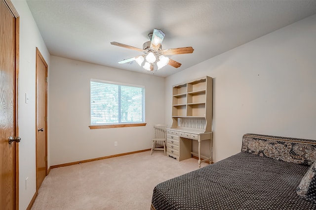 bedroom with light carpet, a textured ceiling, and ceiling fan